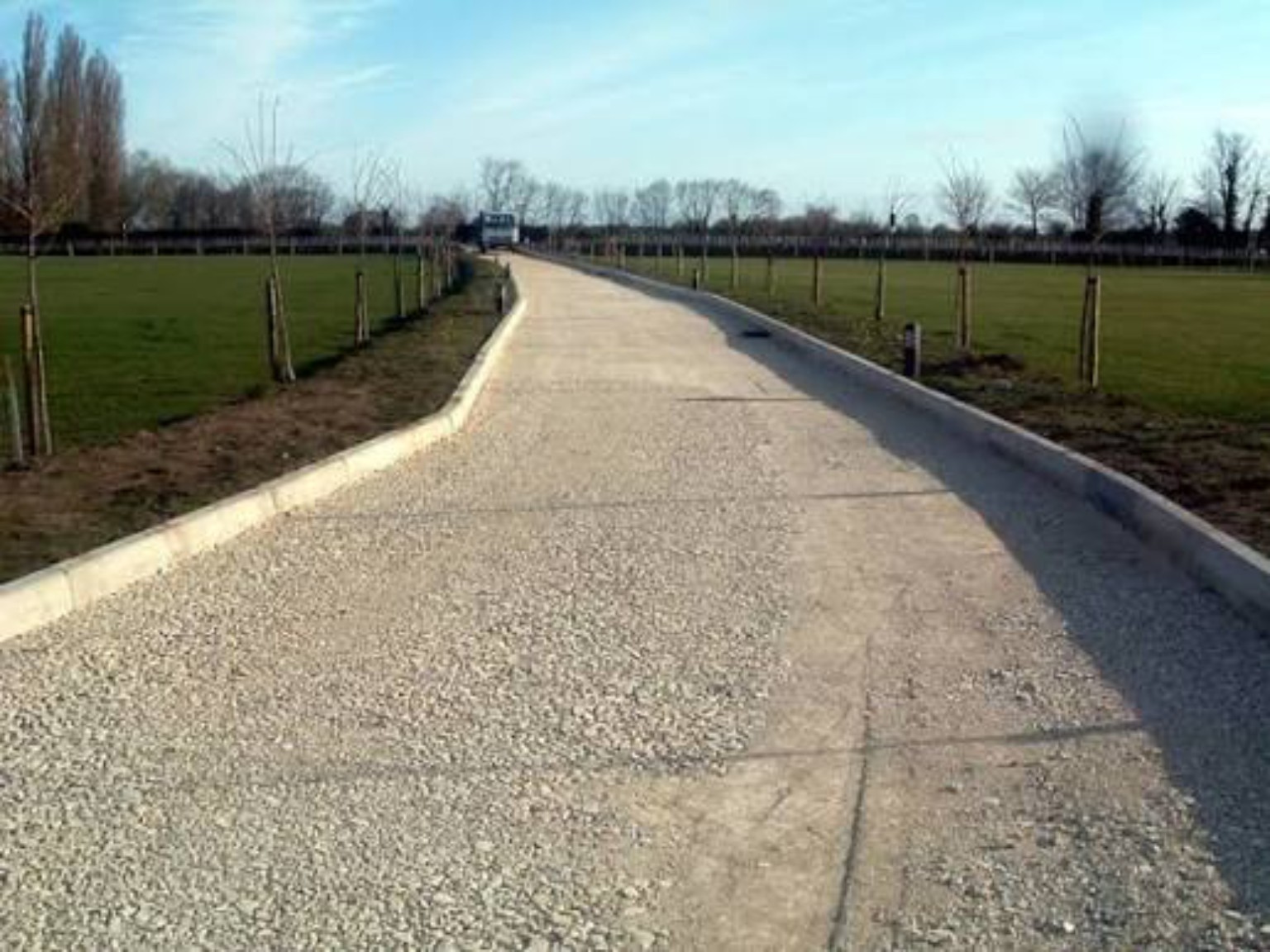 Dumbarton private access road before tarmac laying, showing the prepared stone base between new edging kerbs