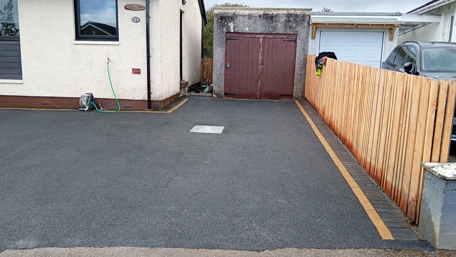 Detail of the completed Fort William tarmac surface and charcoal and buff block-paved border