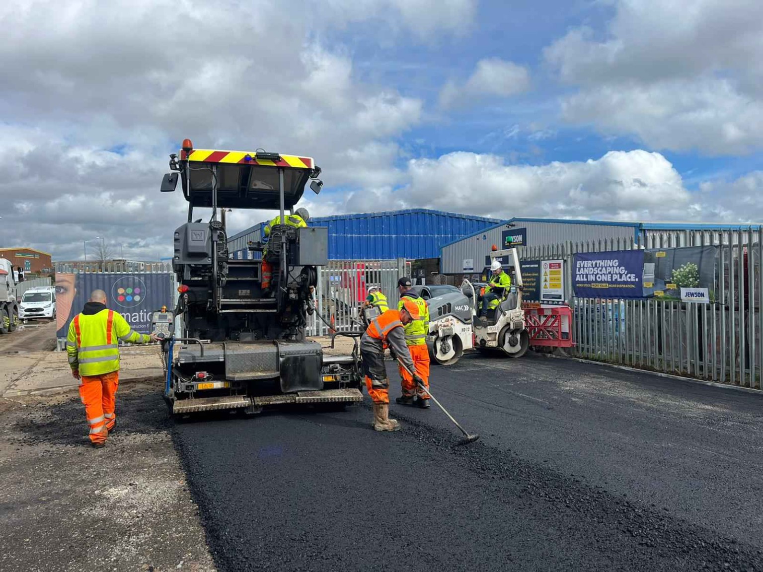 Tarmac paver and surfacing team working beside industrial premises in Montrose, Angus