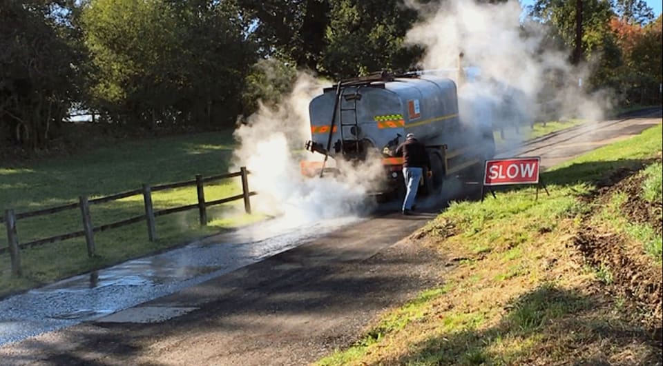 Bitumen binder being sprayed onto a prepared road during surface dressing